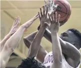  ?? L. TODD SPENCER/STAFF FILE ?? Norfolk Academy standout Mark Williams, now on Boo Williams’ team, fights off a double-team defense and takes a shot in a game against Cape Henry Collegiate.