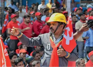  ?? AFP ?? A worker and member of the Centre of Indian Trade Unions shoots video of his colleagues as they protest during a nationwide strike in Bengaluru on Tuesday. —