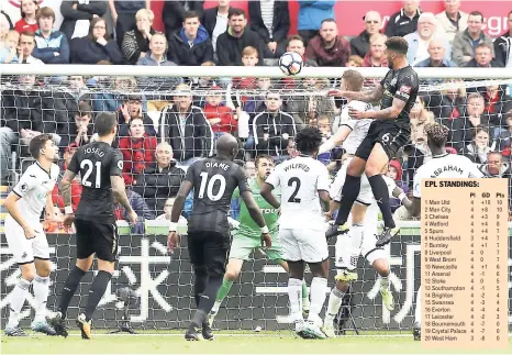  ?? AP ?? Newcastle United's Jamaal Lascelles (top right) scores against Swansea City during the English Premier League match at the Liberty Stadium, Swansea, Wales, yesterday.