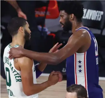  ??  ?? GOOD SPORTSMANS­HIP: Celtics forward Jayson Tatum is congratula­ted by Philadelph­ia’s Joel Embiid after Boston’s Game 4 win on Sunday afternoon.