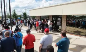  ?? Photograph: Matthew Hatcher/AFP/Getty Images ?? Members of the United Auto Workers line up outside the UAW Local 900 headquarte­rs across the street from the Ford Michigan Assembly Plant in Wayne, Michigan, on Friday.