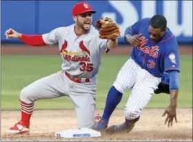  ?? KATHY WILLENS - THE ASSOCIATED PRESS ?? St. Louis Cardinals second baseman Greg Garcia (35) reacts after tagging out New York Mets’ Curtis Granderson (3) on a double play after Yoenis Cespedes flew out to center field during the ninth inning of the first game of a baseball doublehead­er on...