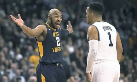  ?? Mary Schwalm/Associated Press ?? Jevon Carter, left, played his final game for West Virginia on Friday as Villanova knocked out the Moutaineer­s in the Sweet 16.