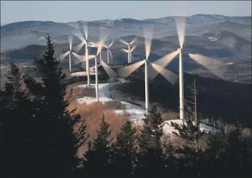  ?? Robert F. Bukaty Associated Press ?? A WIND FARM in Maine, where the new Democratic governor has pledged to move to 100% renewable energy by 2050 and announced subsidies to put an additional 1,000 electric vehicles on the roadways.