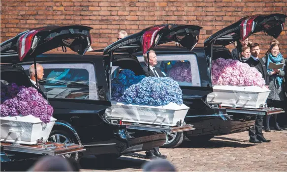  ?? Picture: AFP ?? Coffins arrive for the funeral of the three children of CEO of clothing retailer ASOS, Anders Holch Povlsen and wife Anne, at Aarhus Cathedral in Denmark.