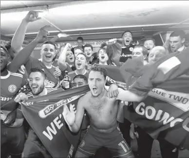  ?? REUTERS ?? Accrington Stanley players celebrate in the dressing room after Tuesday’s 2-0 victory over Yeovil Town clinched them promotion to League One, the third tier of English soccer.