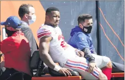  ?? NAM Y. HUH - THE ASSOCIATED PRESS ?? New York Giants running back Saquon Barkley (26) is carted to the locker room after being injured during the first half against the Chicago Bears last Sunday.