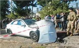  ?? MAHMOUD ZAYYAT/GETTY-AFP ?? Bloodstain­s cover the ground next to a battered vehicle Saturday after an Israeli drone strike near Lebanon’s coastal town of Jadra. Two people were killed.