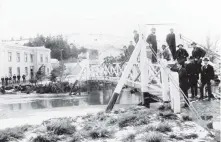  ??  ?? Bustling town . . . A bridge spans the old river.