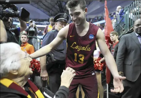  ?? Tribune News Service ?? Clayton Custer of Loyola Chicago greets sister Jean dolores schmidt during the 2018 NCAA tournament. A lot of midmajor schools like Loyola Chicago are hoping to make the 2021 tournament, which begins later this month.