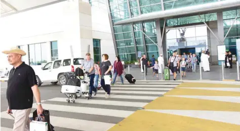  ?? — ONA ?? Russian tourists coming out Salalah Internatio­nal Airport after the traditiona­l welcome organised by the Ministry of Tourism on Monday.