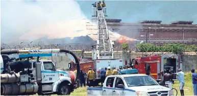  ?? FILE ?? Firefighte­rs trying to contain the blaze at the Tower Street Adult Correction­al Centre in downtown Kingston, which destroyed the George Davis Centre, which housed mentally ill inmates at the prison.