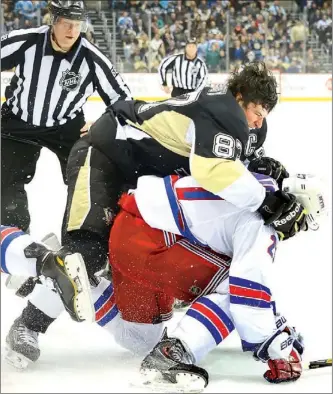  ?? Peter Diana/Post-Gazette photos ?? Sidney Crosby takes down the Rangers Ryan McDonagh in the third period.