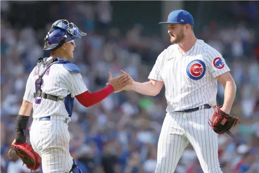  ?? GETTY IMAGES ?? Miguel Amaya congratula­tes Luke Little, who pitched a scoreless ninth inning Wednesday against the Giants. He allowed a hit and had two strikeouts.