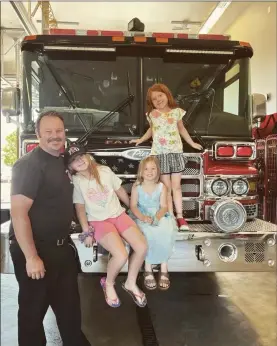  ?? COURTESY PHOTO — CHRIS BELL ?? Rowan Bell, 10, left; Lincoln Bell, 5, middle; and Nova Bell, 7, right; pose with their dad, Fairfield Firefighte­r Engineer Chris Bell, at Fairfield Fire Station 35.