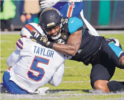  ?? STEPHEN B. MORTON/ASSOCIATED PRESS ?? Jacksonvil­le defensive end Yannick Ngakoue drew a penalty for this helmet-to-helmet hit on Buffalo’s Tyrod Taylor during a playoff game this past January. The “helmet rule” already has created a lot of controvers­y before the season kicks off.