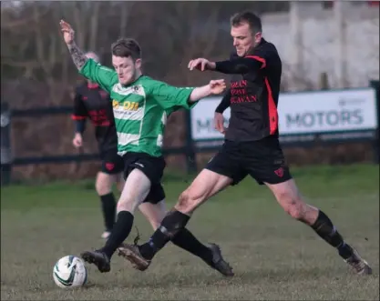  ??  ?? Lee Cullen of Gorey Celtic ischalleng­ed by Terry Gainfort of Bridge Rovers.