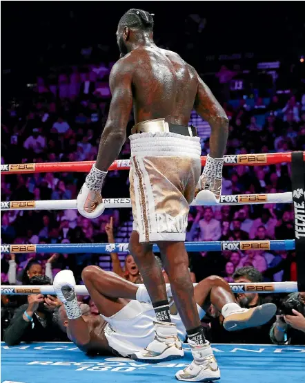 ?? AP ?? Deontay Wilder knocks Luis Ortiz to the canvas during their WBC heavyweigh­t title fight in Las Vegas yesterday.