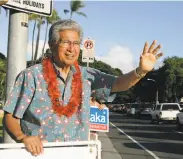  ?? Marco Garcia / Associated Press 2006 ?? Campaignin­g for re-election in 2006, Sen. Daniel Akaka waves to commuters driving by in Honolulu.