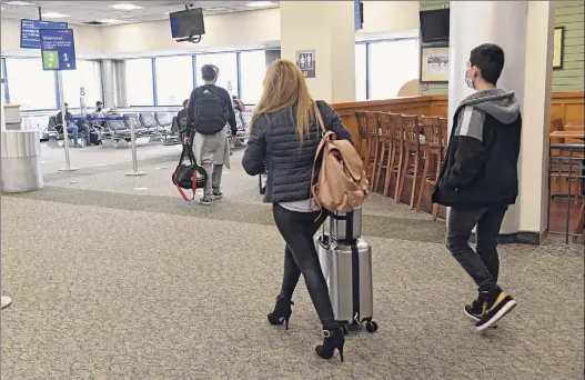  ?? Lori Van Buren / Times Union ?? Albany Internatio­nal Airport officials say the Center for Disease Control and Prevention’s latest advisory is “another step forward for the recovery of the airline industry." Here passengers arrive to their gate before departure on March 24 in Colonie.