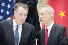  ?? — Reuters file photo ?? US Trade Representa­tive Robert Lighthizer, left, listens as Chinese Vice Premier Liu He talks while they line up for a group photo at the Diaoyutai State Guesthouse in Beijing.