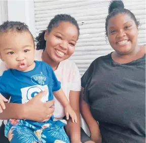  ?? CORRITTALE­WIS ?? Corritta Lewis, center, with her wife, Mea, and their son Caleb, 2, says she is looking forward to staying home with her family and avoiding the overall mania that the holiday brings.