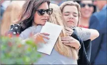  ?? ASSOCIATED PRESS] [GERALD HERBERT/THE ?? Mourners hug Monday as they leave the funeral of 14-yearold Alaina Petty in Coral Springs, Fla.