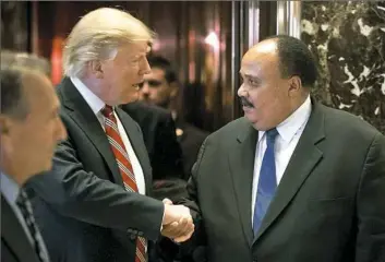  ?? Andrew Harnik/Associated Press ?? President-elect Donald Trump shakes hands with Martin Luther King III, son of Martin Luther King Jr., on Monday at Trump Tower in New York.