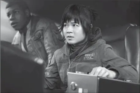  ?? The Associated Press ?? NEWCOMER: Kelly Marie Tran as Rose and John Boyega as Finn, left, in "Star Wars: The Last Jedi," in theaters on Dec. 15.