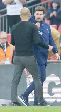  ?? — Reuters ?? Manchester City manager Pep Guardiola shakes hands with Tottenham manager Mauricio Pochettino after the match.