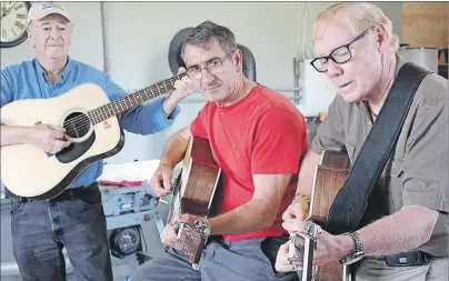  ?? MILLICENT MCKAY/JOURNAL PIONEER ?? John Campbell, from left, Wayne Gallant and Harold Noye play the guitars they made.