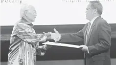  ??  ?? Taib (left) presents a mock cheque of RM50,000 to Mohd Johari.