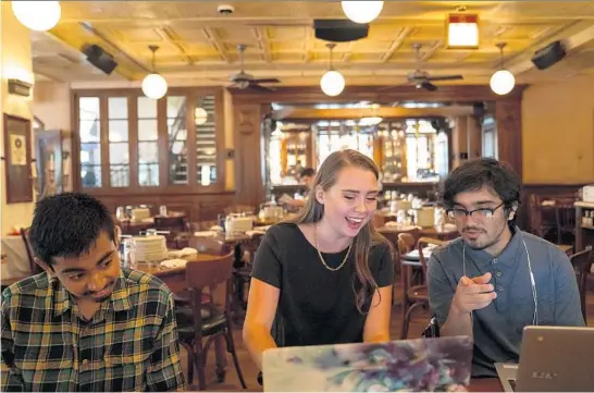  ?? ?? Sydney Gear, center, chats Aug. 25 with Anirudh Paidipally, left, and Xander Vizcarra, who participat­ed in the STEM program she administer­ed for Chicago tech company YolBe.