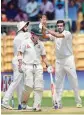  ?? PTI ?? Davis Warner (centre) walks back after Ashwin takes his wicket during the second Test between India and Australia