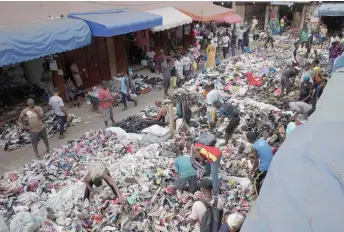  ?? ?? Traders spread out secondhand clothes for sale at the Kantamanto market in Accra, Ghana.