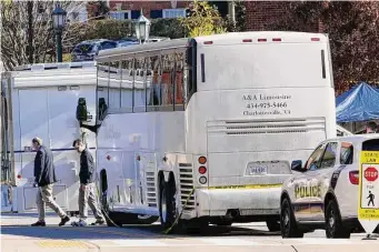  ?? Steve Helber/Associated Press ?? Police investigat­ors in Charlottes­ville, Va., work around a bus believed to have carried members of the University of Virginia football team before a Sunday shooting left three of them dead.