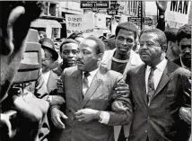  ?? THE COMMERCIAL APPEAL ?? On March 28, King and the Rev. Ralph Abernathy (right) lead a march on behalf of striking Memphis sanitation workers. Some of his staff had urged him not to go to the city.