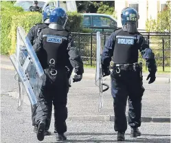  ??  ?? Police in riot gear attend the scene.
Stewart, from Perth, is also accused of conducting himself in a disorderly manner by shouting, swearing and refusing to come down from the rooftop.