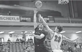  ?? ?? Former Winona State guard Connor Dillon goes up for a shot during a 2023 basketball game. The Peoria Notre Dame all-stater announced his commitment to Bradley this month.