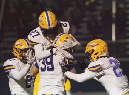  ?? JEN FORBUS — THE MORNING JOURNAL ?? Avon’s Kam Erskine (27) celebrates with Mark Steinmetz (39) during the Eagles’ regional final against Toledo Central Catholic on Nov. 16. The play of Steinmetz on offense has been an x-factor for Avon all season.