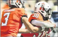  ?? BRODY SCHMIDT — THE ASSOCIATED PRESS ?? Oklahoma State quarterbac­k Spencer Sanders hands the ball off to running back Chuba Hubbard during the first half against Tulsa. Hubbard was limited to 35yards in the first half but scored on a 3-yard run on the first play of the fourth quarter in Oklahoma State’s 16-7victory over Tulsa in the season opener for both teams.