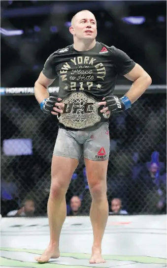  ?? FRANK FRANKLIN II/THE ASSOCIATED PRESS ?? Georges St-Pierre reacts after winning a middleweig­ht title MMA bout against England’s Michael Bisping at UFC 217 in New York.