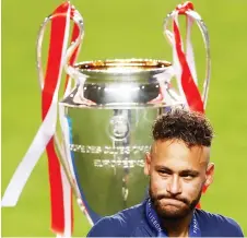  ?? — AFP file photo ?? Neymar reacts as he walks past the trophy after Bayern Munich won the UEFA Champions League final match against Paris Saint-Germain at Luz stadium in Lisbon.