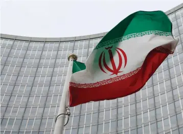  ??  ?? AN IRANIAN flag flutters in front of the Internatio­nal Atomic Energy Agency headquarte­rs in Vienna.