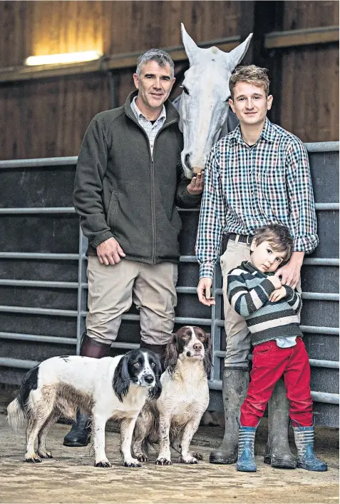  ??  ?? Huntsman Ivan Massow, master of the Southdown and Eridge Hunt, with partner Ed and his son Theo