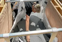  ?? ?? Renee Jacobsen reaches into one of the recycling bags that the flooring company supplies for constructi­on sites.