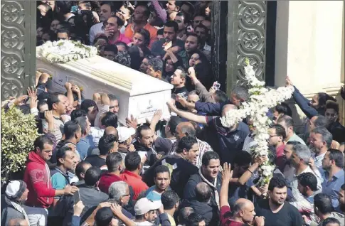  ?? AFP/Mohamed El-Shahed ?? Cristianos coptos con el ataud de uno de los fallecidos en el atentado del autobús, en la provincia de Minia