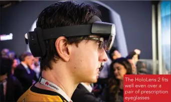  ??  ?? The HoloLens 2 fits well even over a pair of prescripti­on eyeglasses