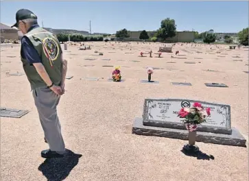  ??  ?? M I YA M U R A visits the grave of his wife, Terry, who died two years ago. They raised three children in Gallup. Miyamura lives in the same modest ranch house he bought in 1954, after he returned from the Korean War.