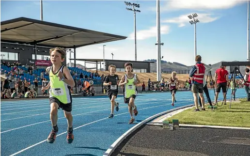  ?? DAVID WALKER/ STUFF ?? Children compete on the newly opened athletics track at Christchur­ch sports hub Nga¯ Puna Wai.